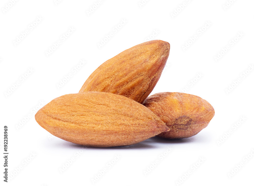 Heap of almonds closeup, isolated on a white background