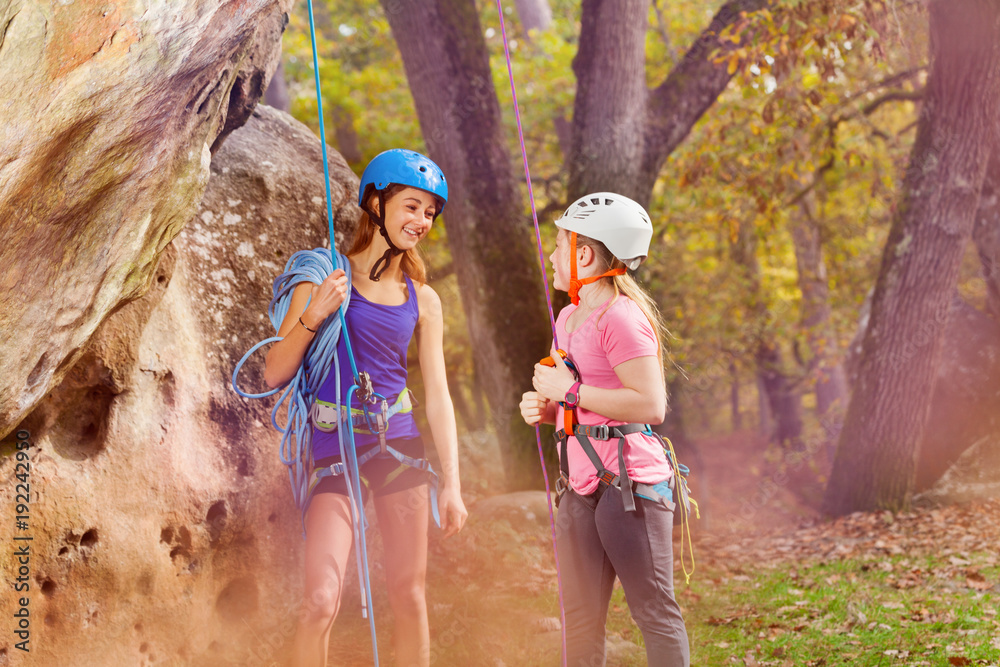 Rock climbing trainer and girl in special outfit