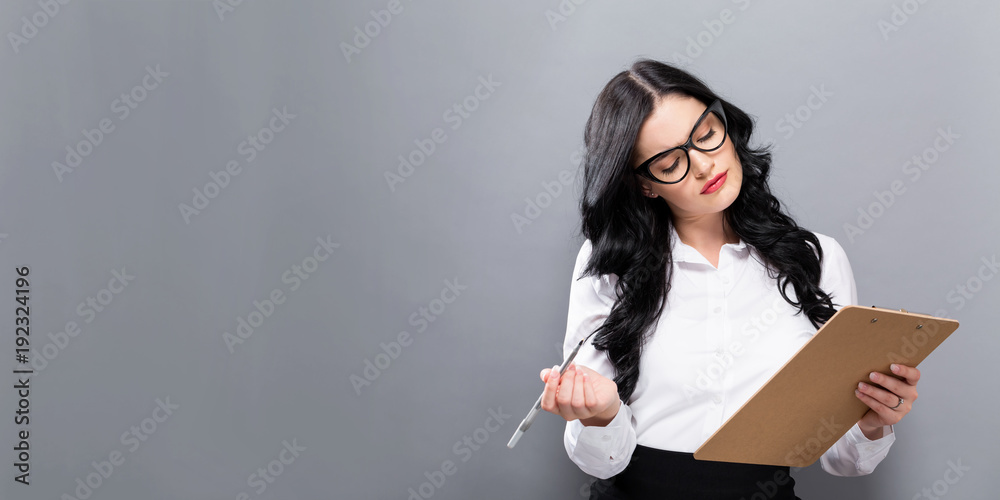 Office woman with a clipboard on a solid background