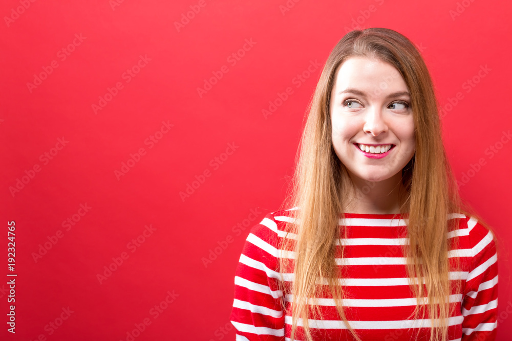 Young woman thinking on a solid background