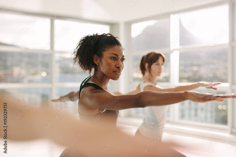 Women doing stretching and yoga workout at gym