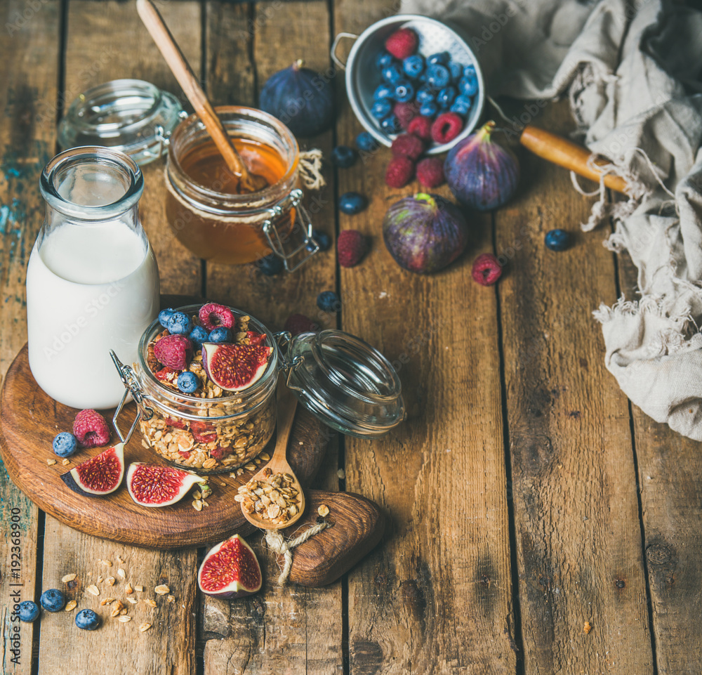 Healthy vegan breakfast. Oatmeal granola with bottled almond milk, honey, fresh fruit and berries on