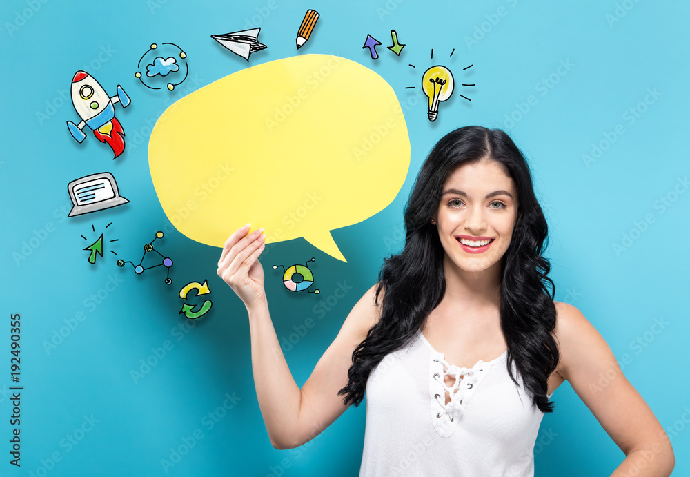 Young woman holding a yellow speech bubble