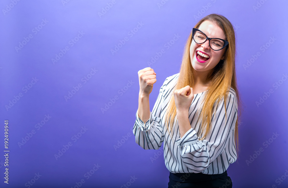 Successful young woman on a solid background