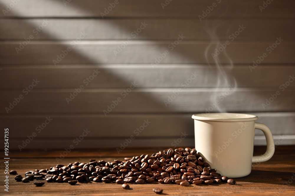 Cup of coffee with smoke and coffee beans on wooden background, This image with no smoke is availabl