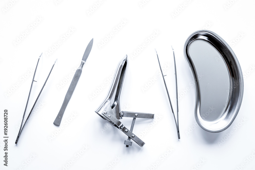 instruments of gynecologist on white background top view