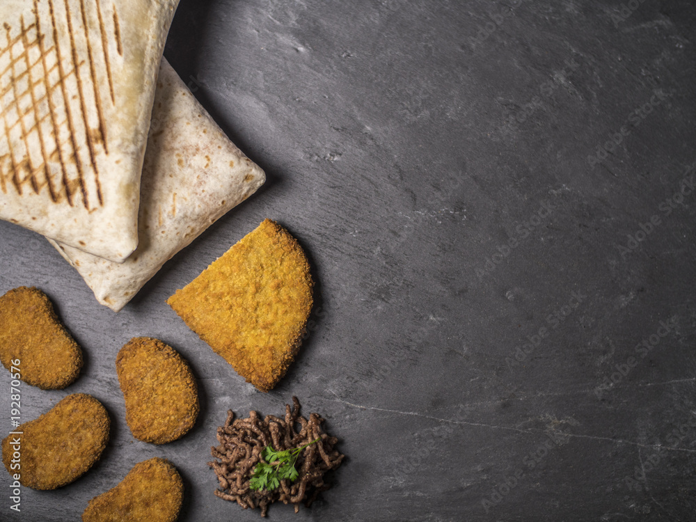 Snack Composition with French Tacos, Cordon Bleu, Nuggets and Beef on slate