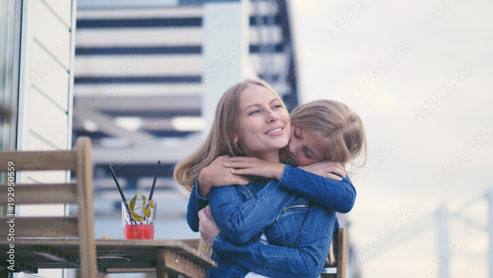 Hugging mother and daughter