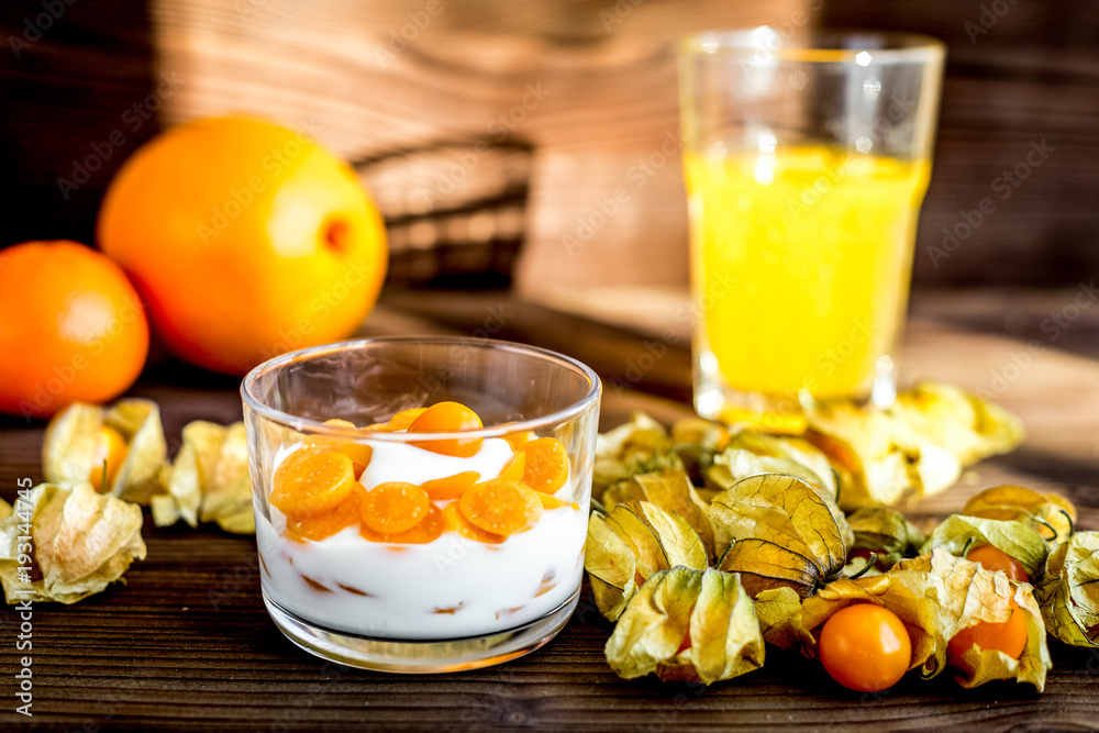 yogurt with physalis on wooden background