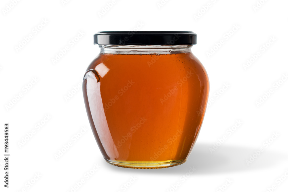 Honey in jar isolated on white background.