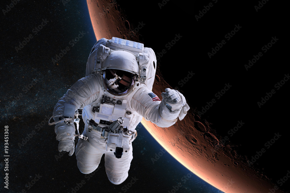 Astronaut in outer space on background of the Mars. Elements of this image furnished by NASA.