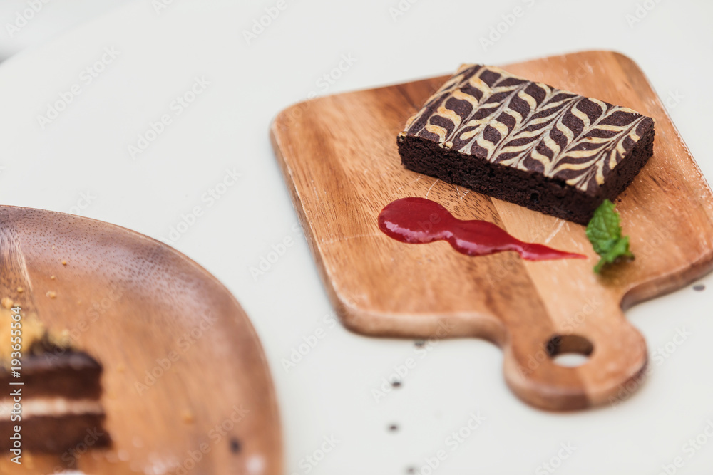 ิbeautiful desert cake on wooden tray