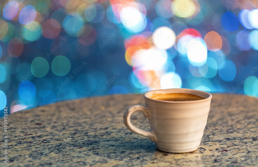 Coffee on a table high above the city lights at night