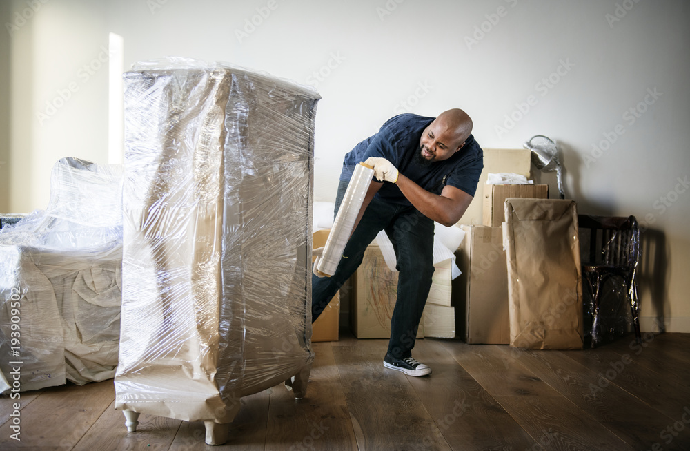 Black man moving furniture