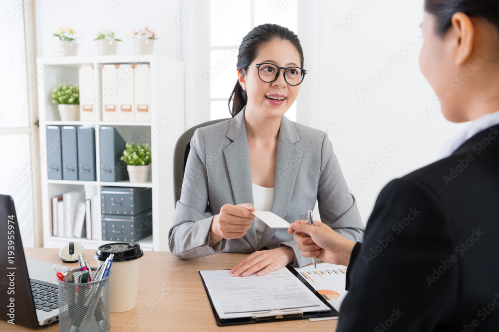 employee give business card to boss