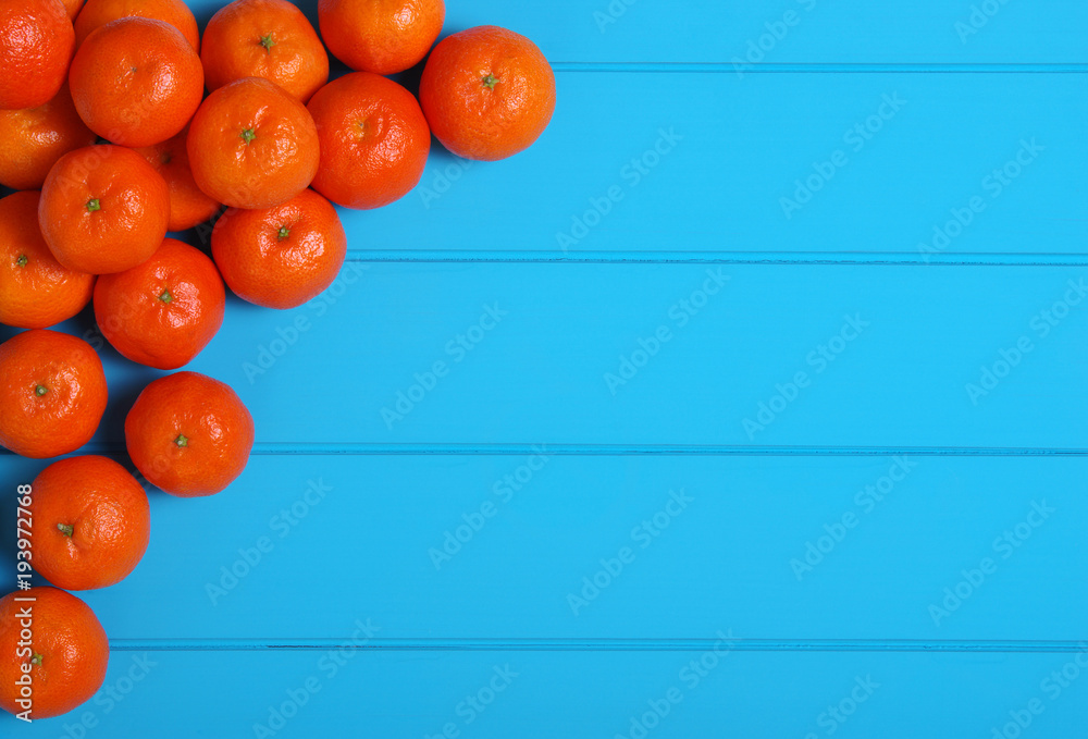 Tangerine on wood table.