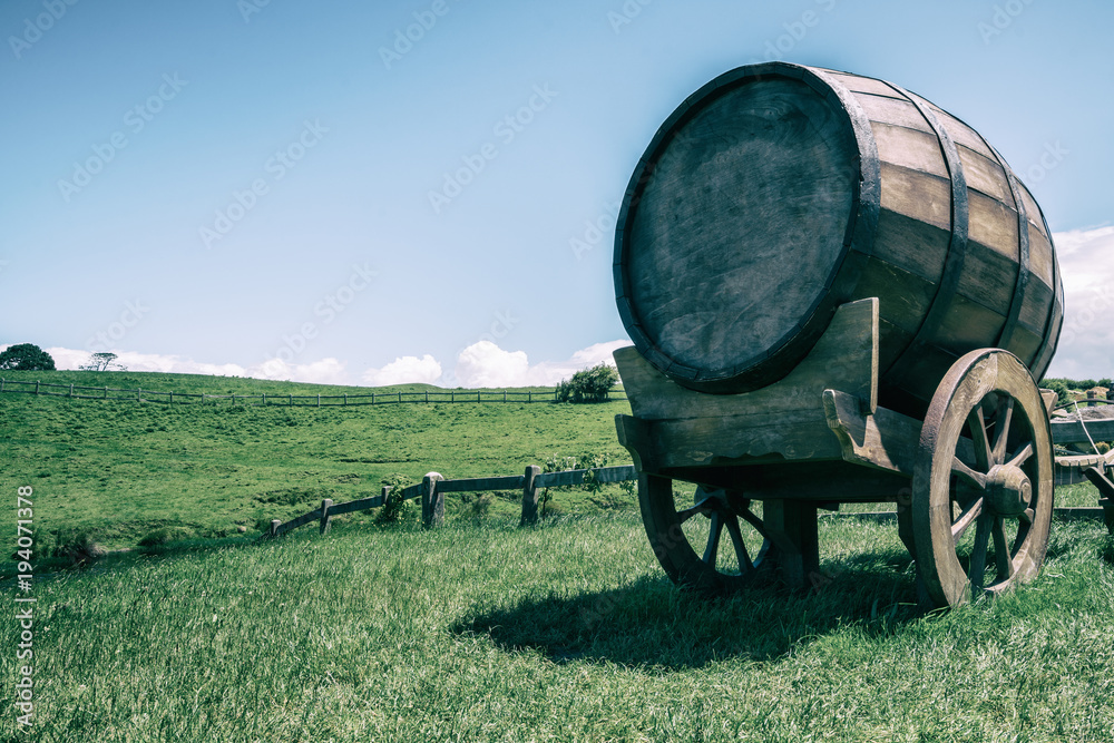 Wine Barrel in Green Grass Field in Vintage Tone