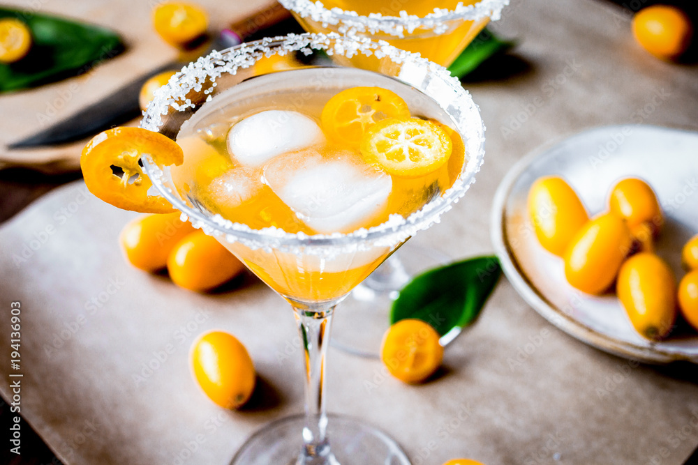 cocktail with kumquat on wooden background