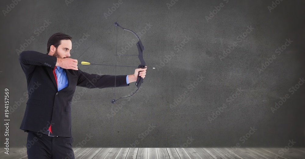 Businessman shooting arrow