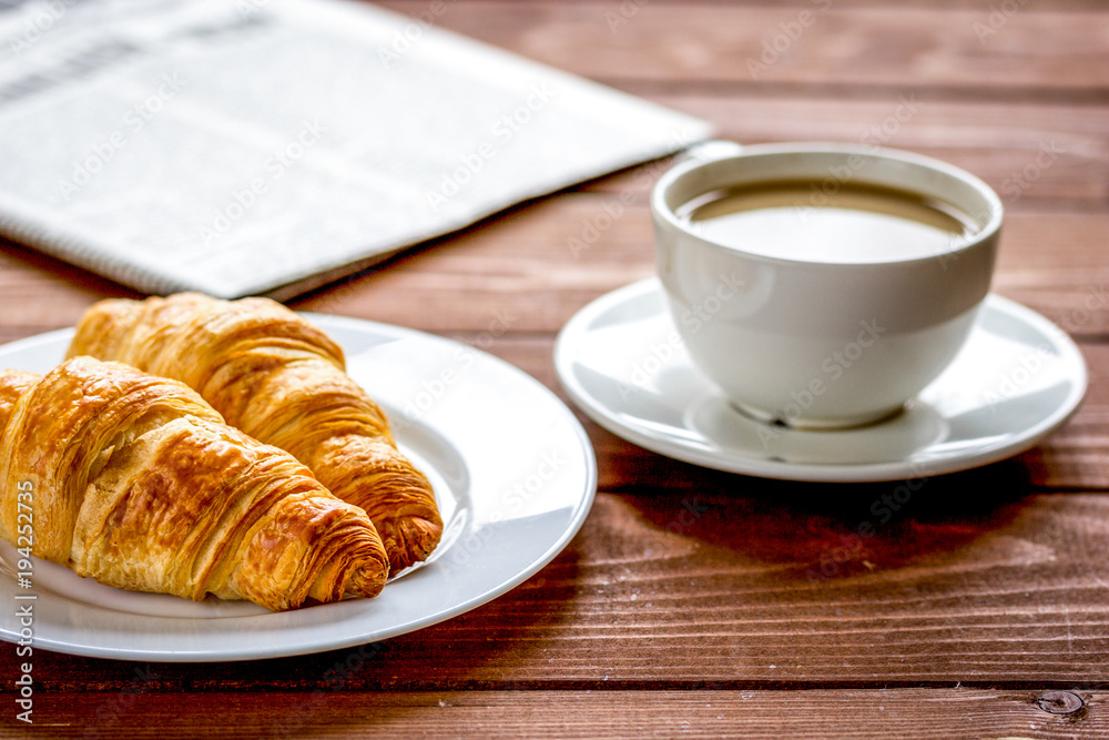 Businessman morning cup of coffee at home with newspaper