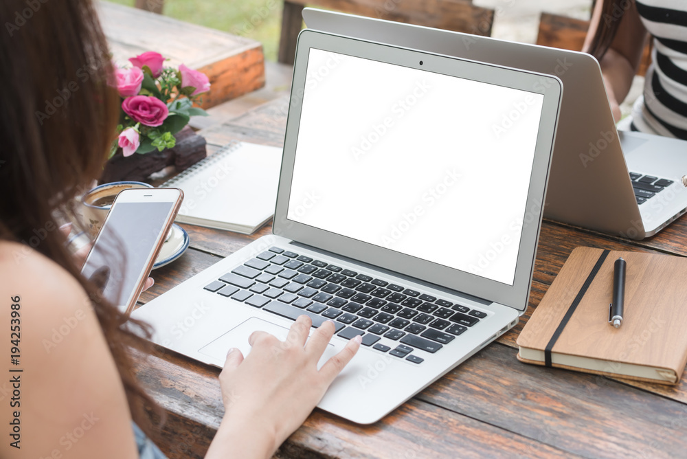 Two Beautiful freelance woman work with laptop and smartphone in coffee shop, modern generation life