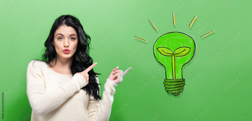 Eco Light Bulb with young woman on a green background