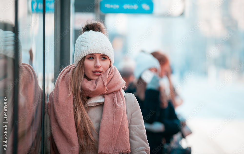 Urban woman standing out from the crowd at city street