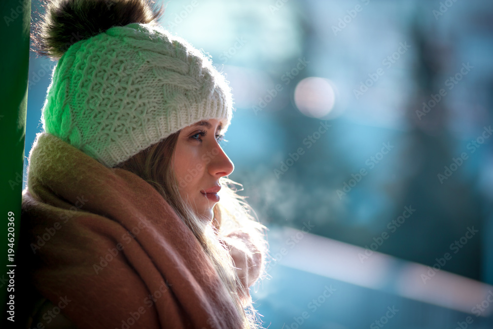 Happy beautiful woman in the city street at winter time