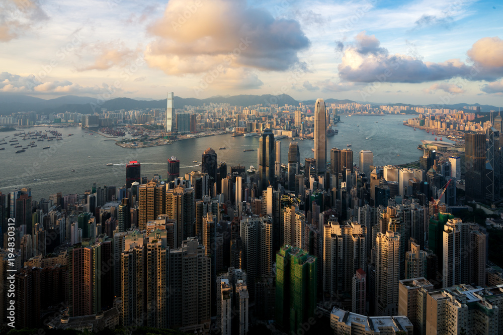 Aerial view of Hong Kong skyline and Victoria Harbor at sunset time in Hong Kong. Asia..