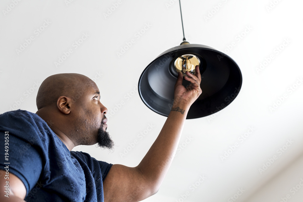 Man fixing a light bulb