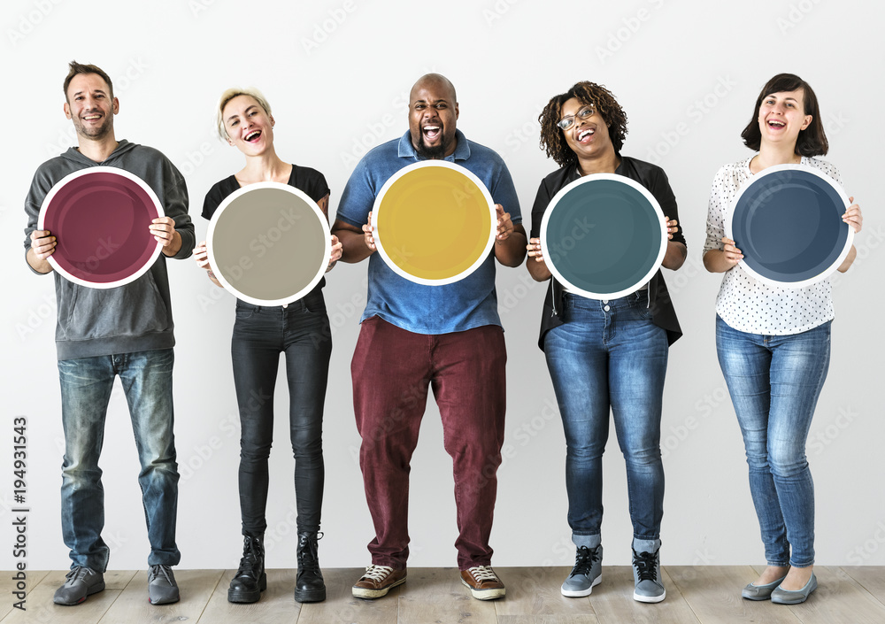 Diverse people holding blank round board