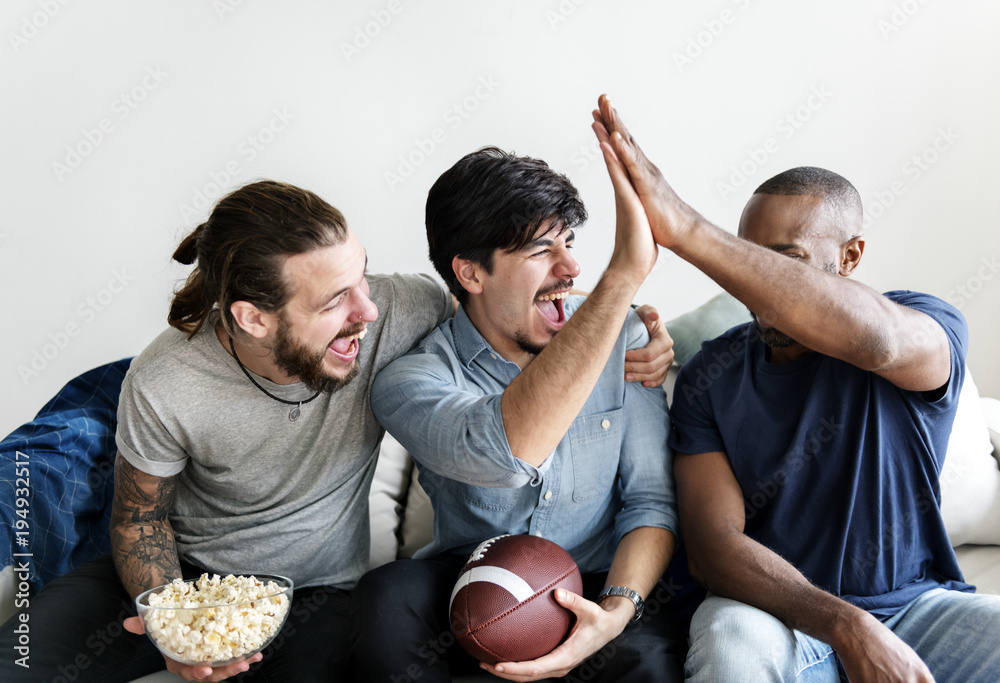 Friends cheering sport league together