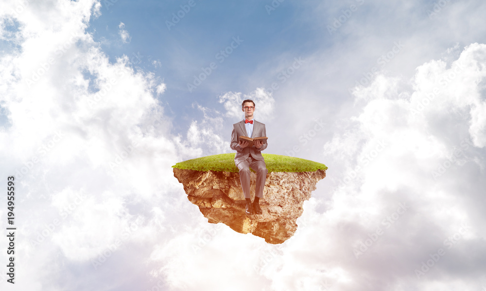 Young businessman or student floating in sky and studying the science