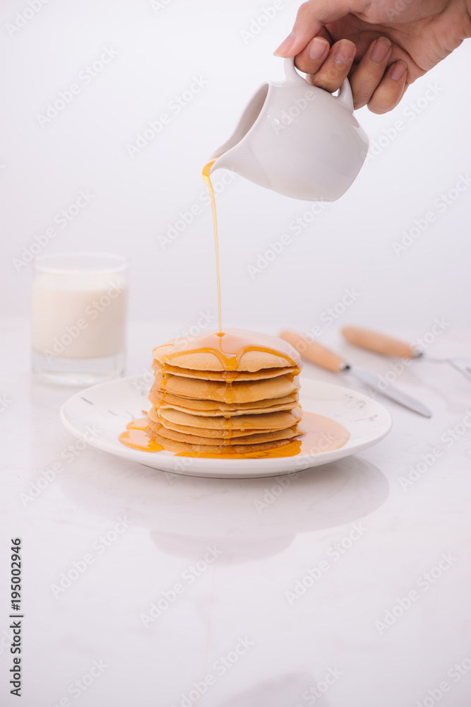 Pancakes for breakfast with honey and milk.