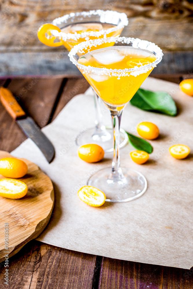 cocktail with kumquat on wooden background