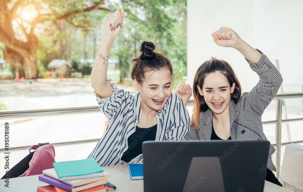 A group of teenage student in university smiling and using the laptop to learning the reason and doi