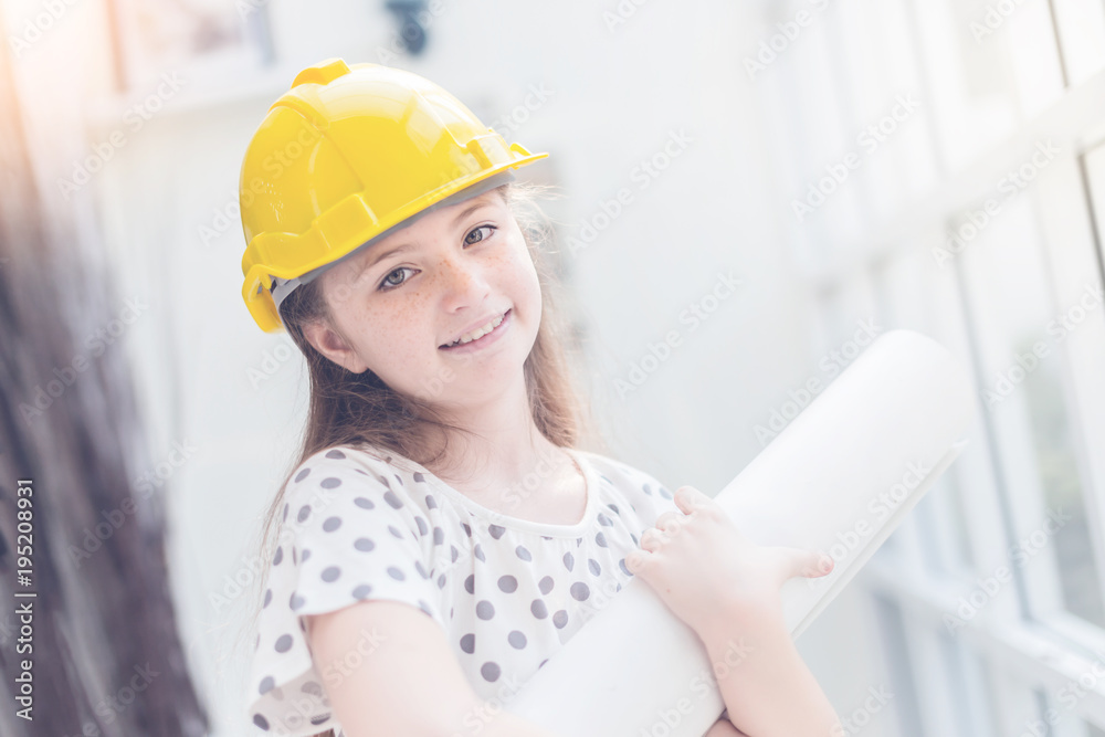 cute and pretty caucasian girl is costume for engineer career with blur background