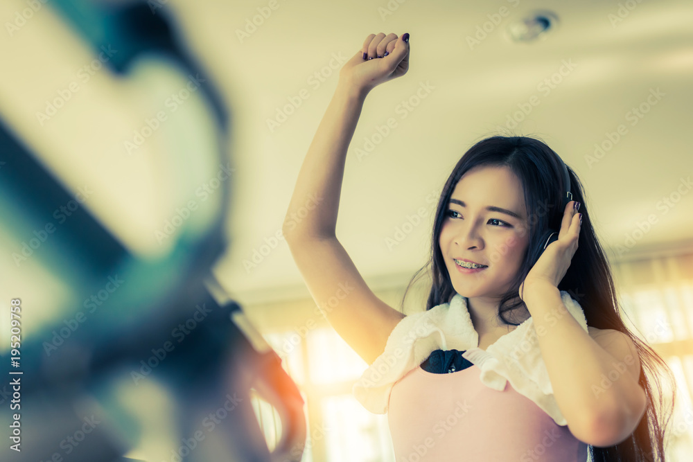 sport beautiful asian girl running on treadmill in sport club health concept