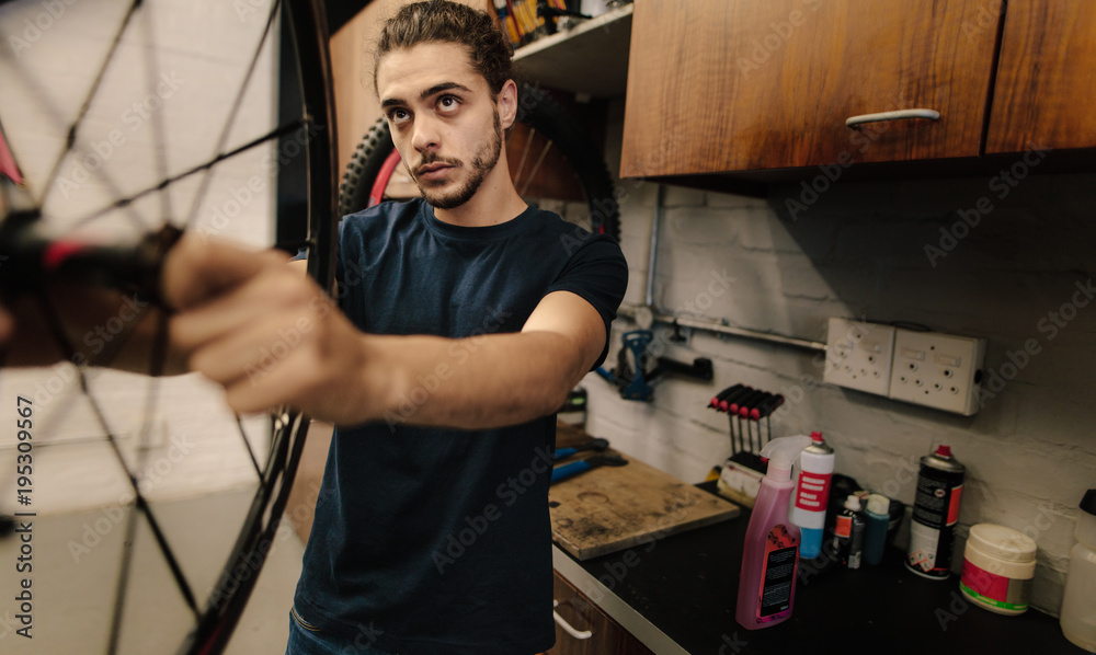 Mechanic repairing a bicycle in workshop