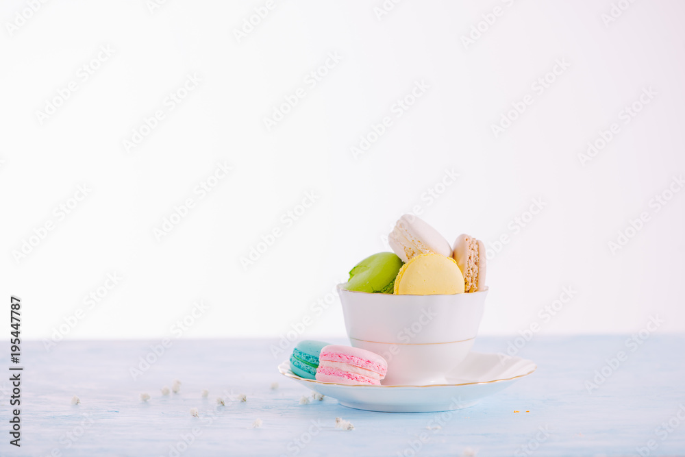 Sweet dessert. Colorful macarons on table in morning.