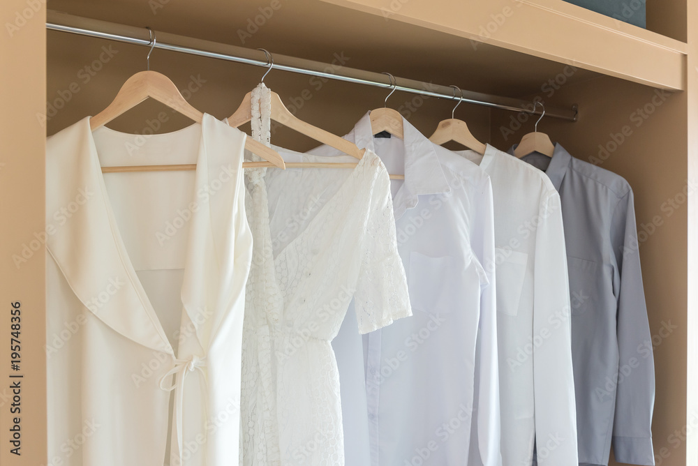 white color shirts hanging on rail