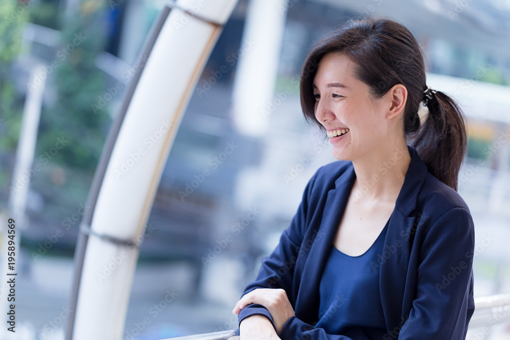 beautiful asian smart woman in navy color suit portrait outdoor location