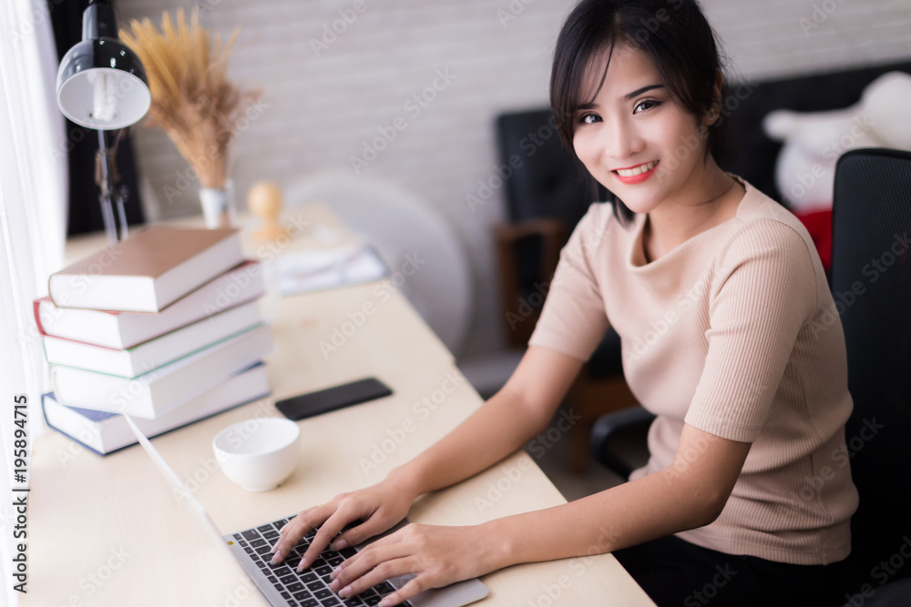 asian beautiful fashion designer  working at home with sketch book model stand