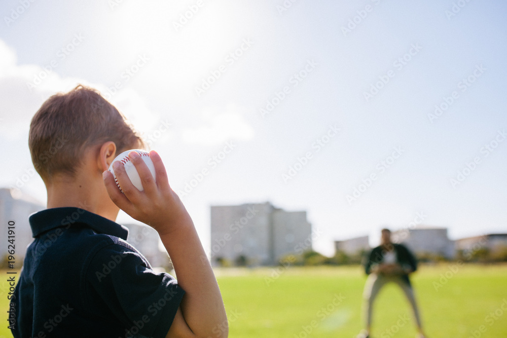 Boy playing with a baseball at a park