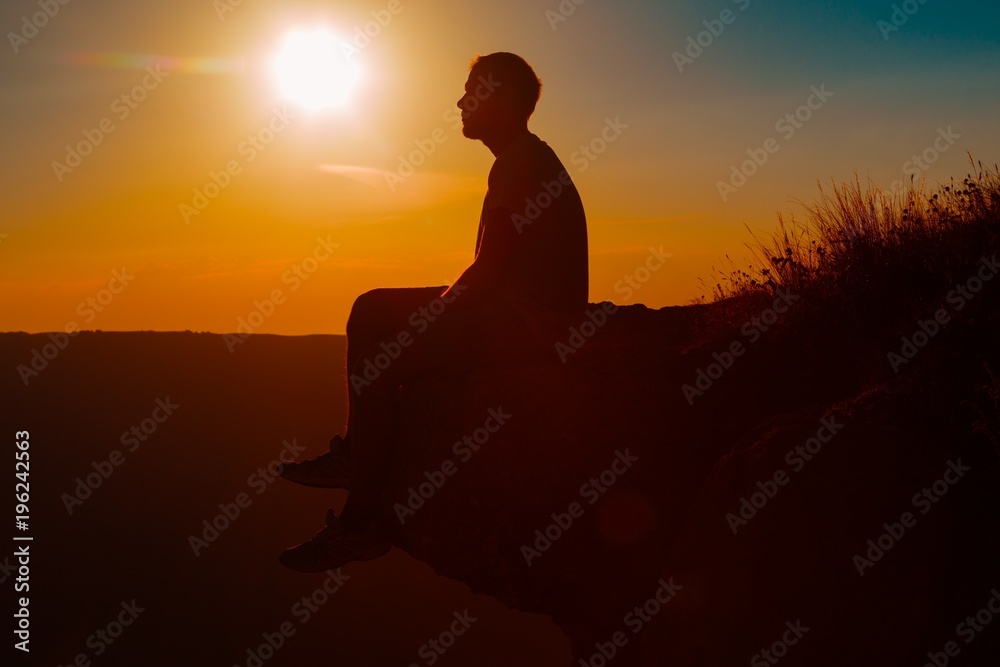 Man Sitting on Rock