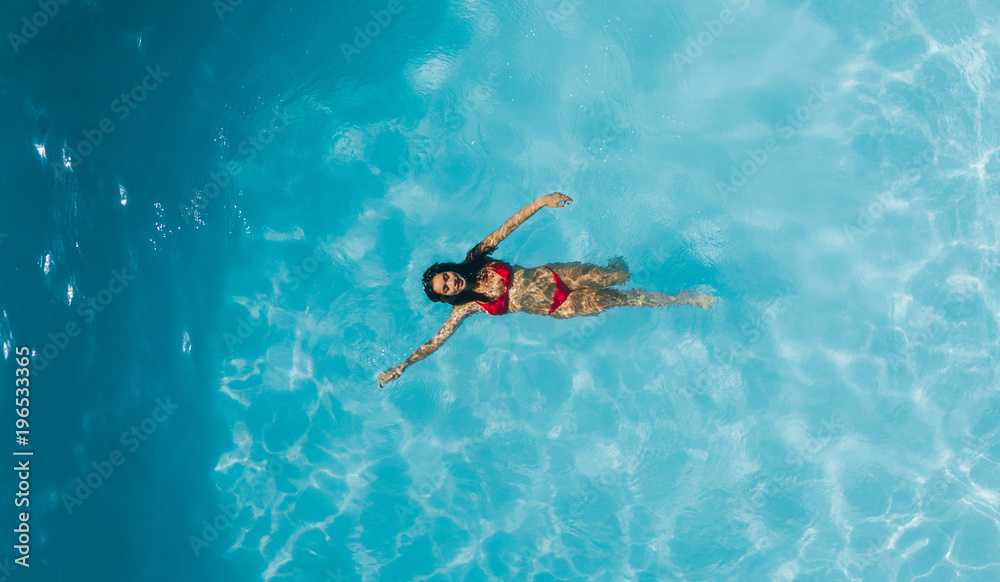 Woman enjoying swimming in a pool