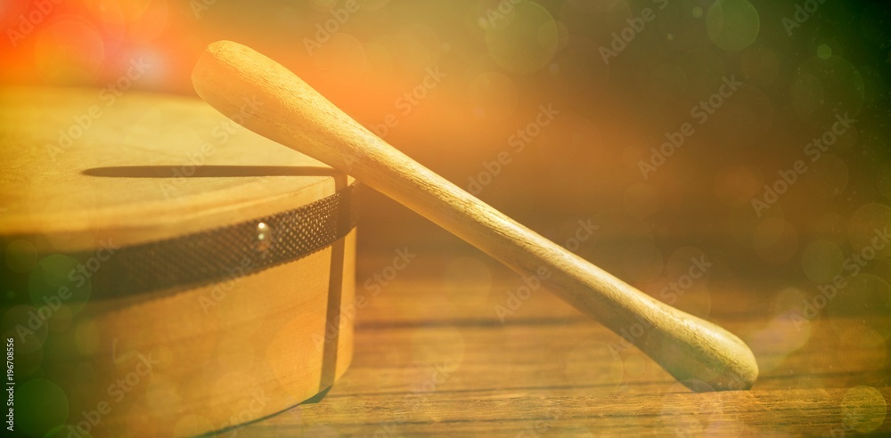 Cropped image of wooden bodhran with stick