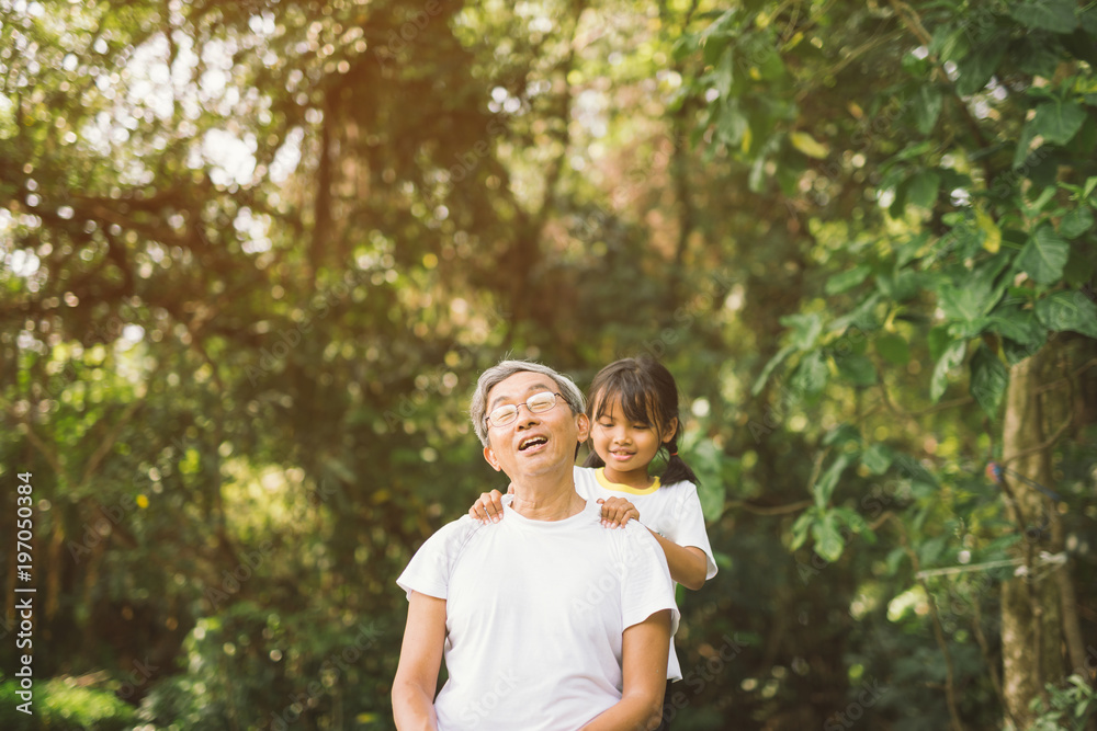 Cute little girl healing massage grandfather