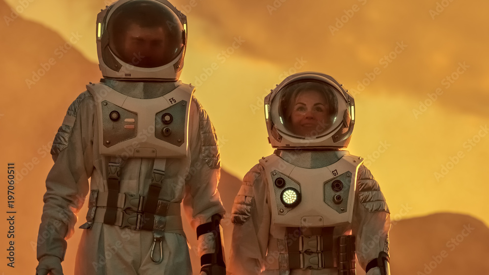 Two Astronauts Wearing Space Suits Walk Exploring Mars/ Red Planet. Space Travel, Exploration and Co