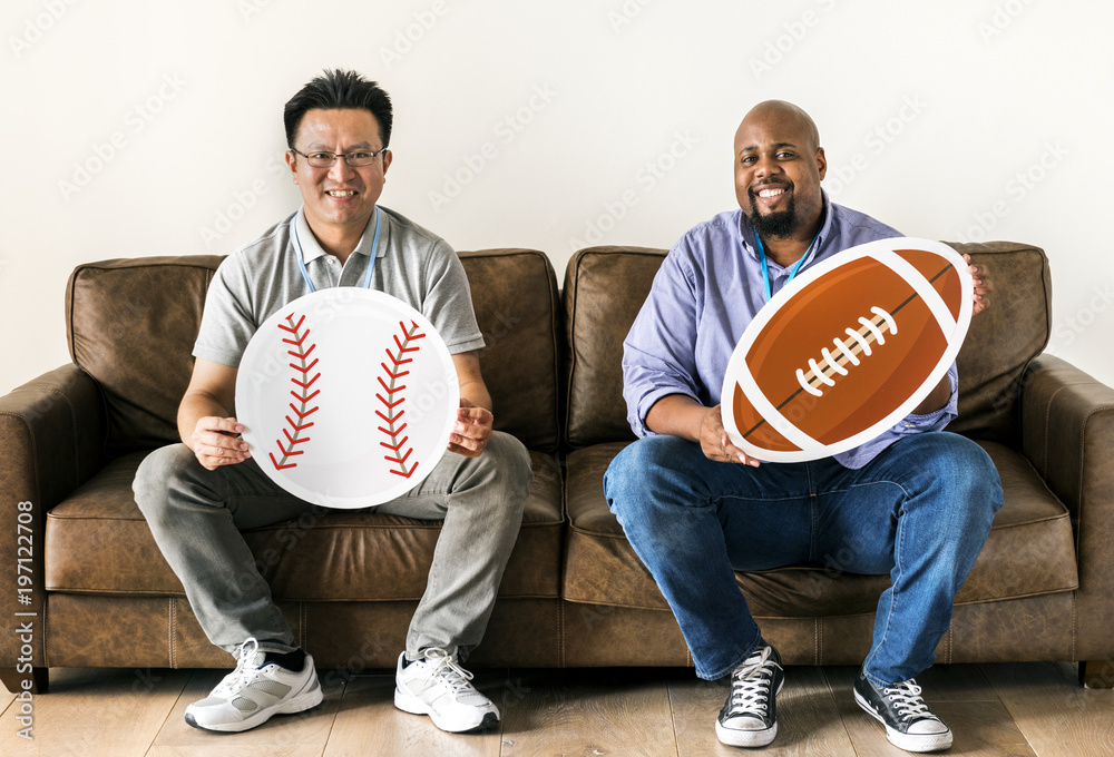 Men holding baseball and rugby icons